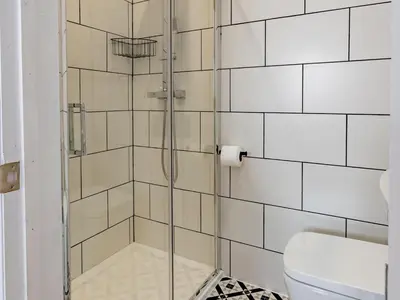 a glass shower in a bathroom with a toilet at Hawkwell Hideaway Large 4 bedroom Home Hockley - Pass the Keys in Hawkwell