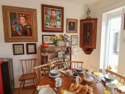 a dining room with a table with food on it at The Orchard Close Art House in Great Livermere
