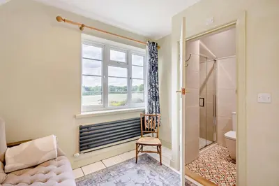 a bathroom with a window and a chair and a shower at 2 Bed in Holbrook oc-31111 in Holbrook