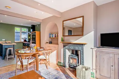 a living room with a table and a fireplace at 2 Bed in Holbrook oc-31111 in Holbrook