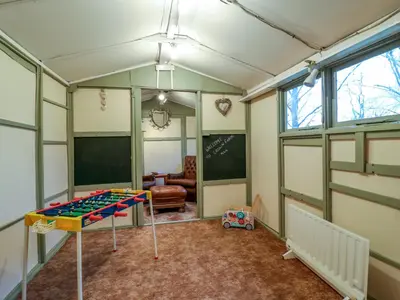 a room with a play table in the middle of a room at Crown Farm in Wisbech