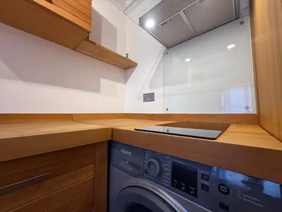 a washing machine in a kitchen with a counter at The Tetris Retreat in Cambridge