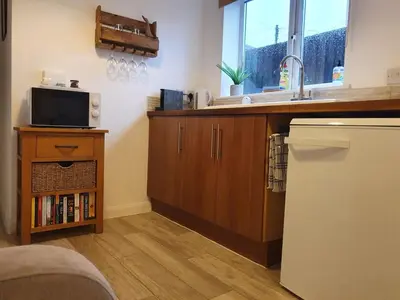 a kitchen with a sink and a counter top at The Nest in Needingworth