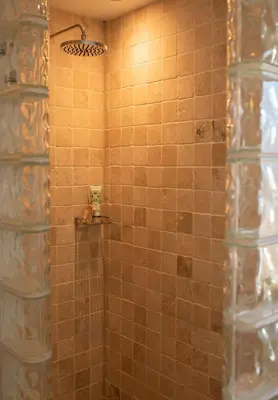 a bathroom with a shower with brown tile at Stylish 3-Bedroom Detached Home in Cambridge in Chesterton