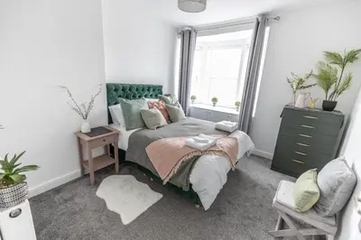 a bedroom with a bed and a window at Brandon Apartment in Town Centre with parking in Brandon
