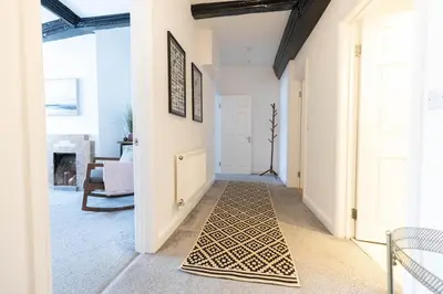 a hallway with a door with a rug on the floor at Brandon Apartment in Town Centre with parking in Brandon