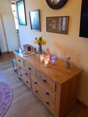 a wooden dresser with candles on top of it at Wisteria Barn in Harleston