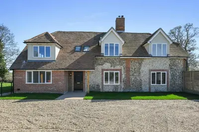 a large brick house with a gravel driveway at Bakers Cottage, Blackmore End in Gosfield