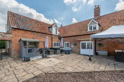a brick house with a patio and a grill at 4 Bed in East Harling oc-m31907 in East Harling