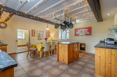 a kitchen and dining room with a table and chairs at 4 Bed in East Harling oc-m31907 in East Harling