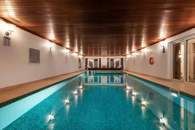 an indoor swimming pool with a large pool at Merry Lakes - Luxury Lakeside Escape with Pool - Just 30 Minutes from London in Hutton