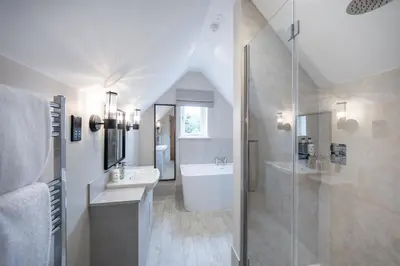 a bathroom with a shower and a sink and a tub at The Ship Hotel in Southend-on-Sea