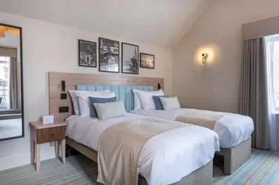 a hotel room with two beds and a window at The Ship Hotel in Southend-on-Sea
