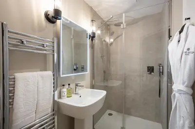 a bathroom with a sink and a shower at The Ship Hotel in Southend-on-Sea