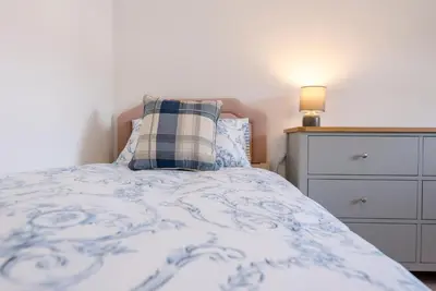 a bedroom with a bed with a pillow and a dresser at The Old Dairy, Cookley in Cookley