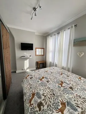 a bedroom with a bed with a blanket with deer on it at Dolce Vita on Sea in Southend-on-Sea