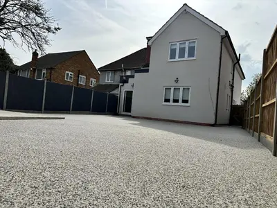 a white house sitting on top of a driveway at Abbey Rooms in Waltham Abbey