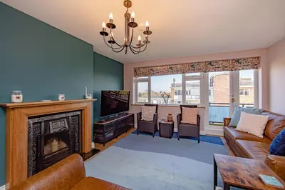 a living room with a couch and a fireplace at Coastal Charm In Clacton On Sea in Holland-on-Sea