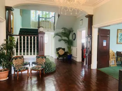 a living room with chairs and a chandelier at The Cobham Hotel in Southend-on-Sea