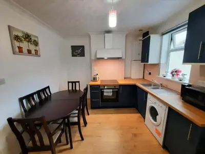 a kitchen with a table and chairs and a dining room at Cozy Seaview Flat in Clacton-on-Sea