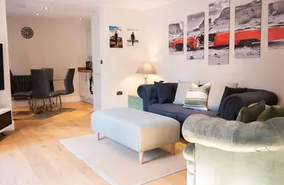 a living room with a couch and a table at Vineyard Style 2BR with Garden and Parking in Shudy Camps