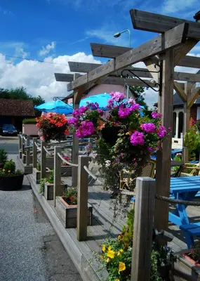 a bunch of flowers on a wooden fence at The Railway Inn Westerfield in Ipswich