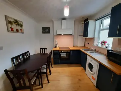 a kitchen with a table and chairs and a dining room at Seafront 2-Bed Apt Sleeps 4 in Clacton-on-Sea in Clacton-on-Sea