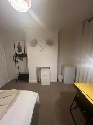 a room with a bed and a desk and a room with a bed at Golden House in Waterbeach