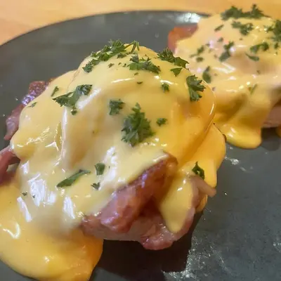 a plate of food with cheese and bacon on it at The White Hart Hotel Witham in Witham