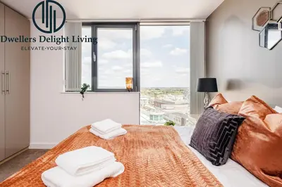 a bedroom with a bed with a large window at Penthouse Panoramic 2 Bedroom -Basildon Essex in Laindon
