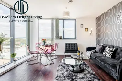 a living room with a couch and a table at Penthouse Panoramic 2 Bedroom -Basildon Essex in Laindon