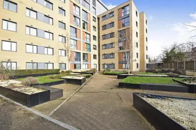 a courtyard in front of a building with benches at Penthouse Panoramic 2 Bedroom -Basildon Essex in Laindon