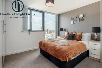 a bedroom with a large bed and a window at Penthouse Panoramic 2 Bedroom -Basildon Essex in Laindon