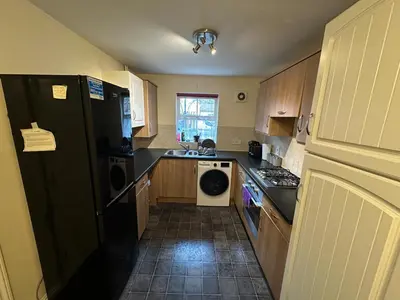 a kitchen with a black refrigerator and a dishwasher at Cosy En-suite Rooms - Ipswich in Ipswich