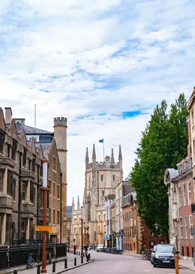 a city street with buildings and a car on the road at Cosy Home Opposite Addenbrookes Hospital - Free Parking in Cambridge