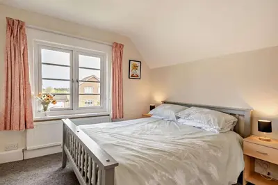 a bedroom with a large white bed and a window at 3 Bed in Bawdsey oc-p31139 in Bawdsey