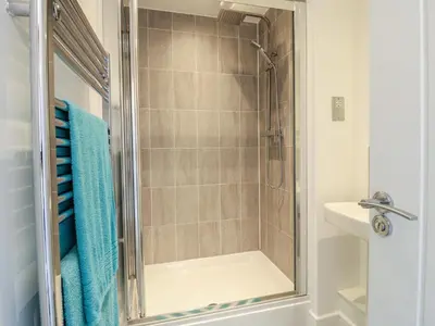 a bathroom with a shower and a sink at 21 Skippers Way in Walton-on-the-Naze