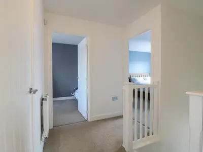 a hallway with a door leading into a room at 21 Skippers Way in Walton-on-the-Naze