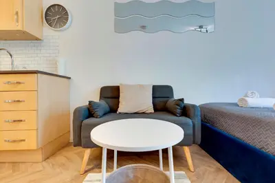 a living room with a couch and a table at Pass the Keys Stylish and modern apartment in Cambridge