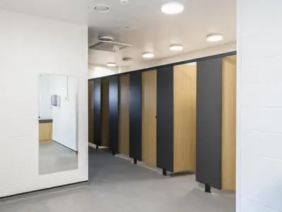 a row of lockers in a hallway with a mirror at Buttercup Cow Shed 3 in Woodbridge