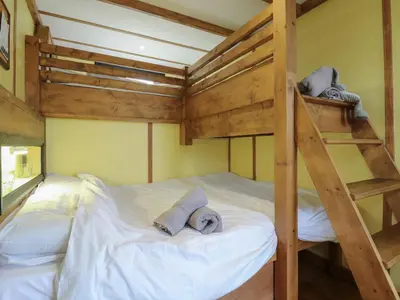 a bedroom with a bunk bed with two towels at Betsy Cow Shed 2 in Woodbridge