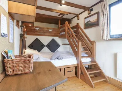 a small bedroom with a bunk bed and a desk at Daisy Cow Shed 1 in Woodbridge