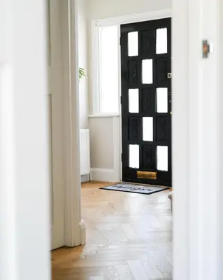 a room with a black door and a wooden floor at Relaxing home Leigh on Sea in Southend-on-Sea