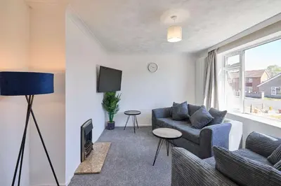 a living room with a couch and a tv at Host & Stay - Park View in Thetford