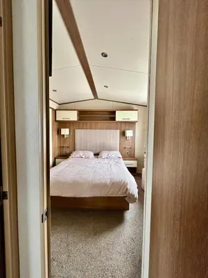 a bedroom with a large bed in a room at VerbLake 5 Berth Caravan St Osyth Beach Holiday Park in Saint Osyth