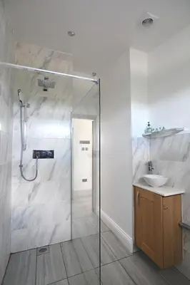 a bathroom with a shower and a sink at Beautiful Lodge in Newmarket with parking in Newmarket