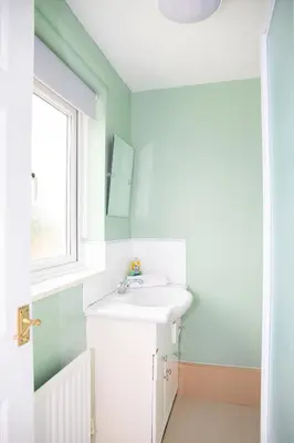 a bathroom with a sink and a window at Stylish and Spacious 3-Bed House Free Parking in Ipswich