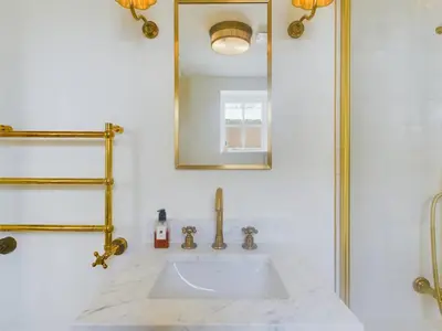 a bathroom with a sink and a mirror at Stunning Heritage Cottage- The Heart of Old Leigh in Southend-on-Sea