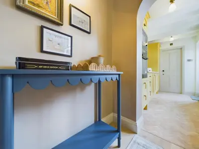 a living room with a blue fireplace in a house at Stunning Heritage Cottage- The Heart of Old Leigh in Southend-on-Sea