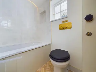 a bathroom with a toilet and a bath tub at Stunning Heritage Cottage- The Heart of Old Leigh in Southend-on-Sea